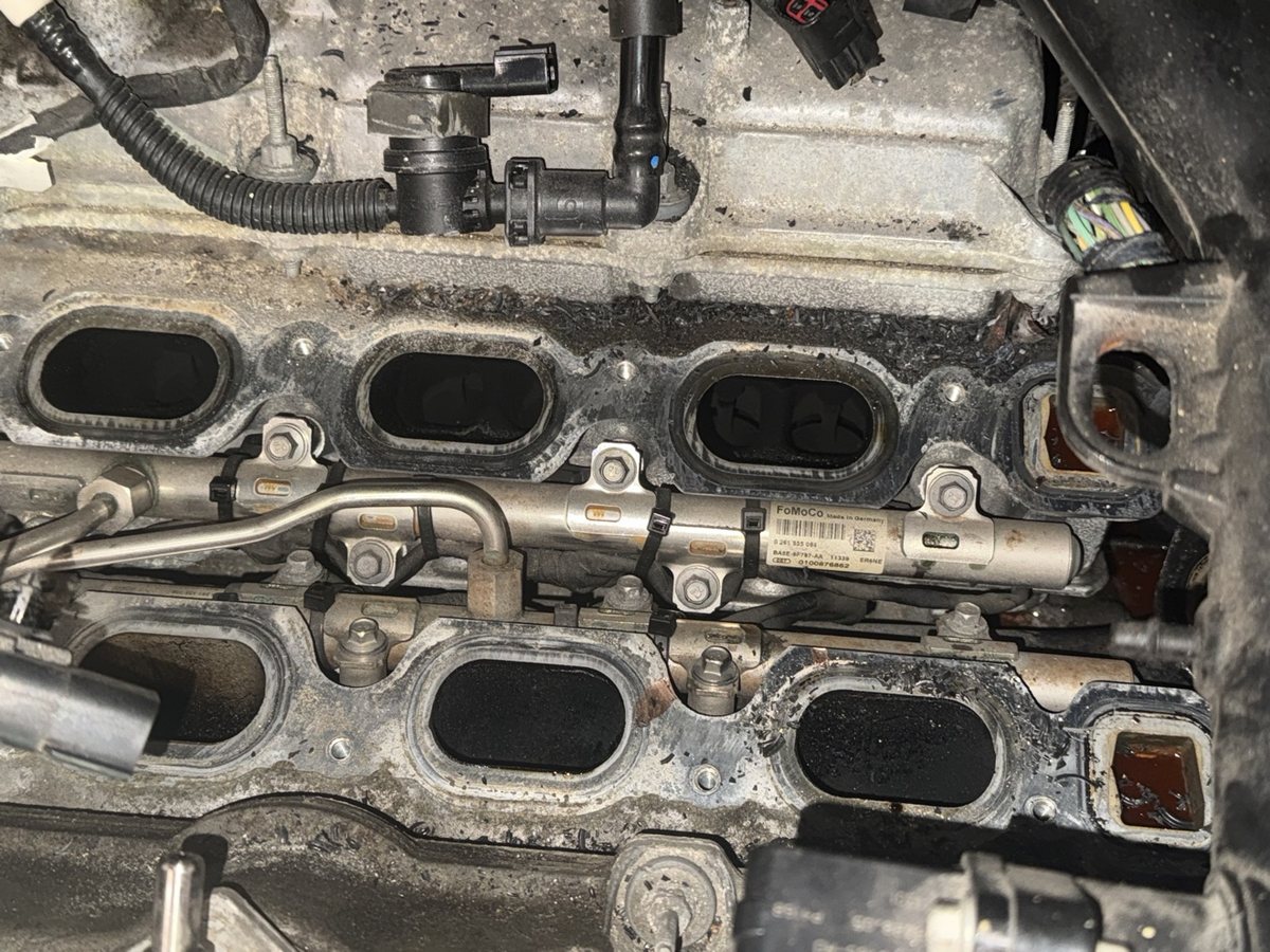 Intake ports heavily caked with carbon during an intake-off service
