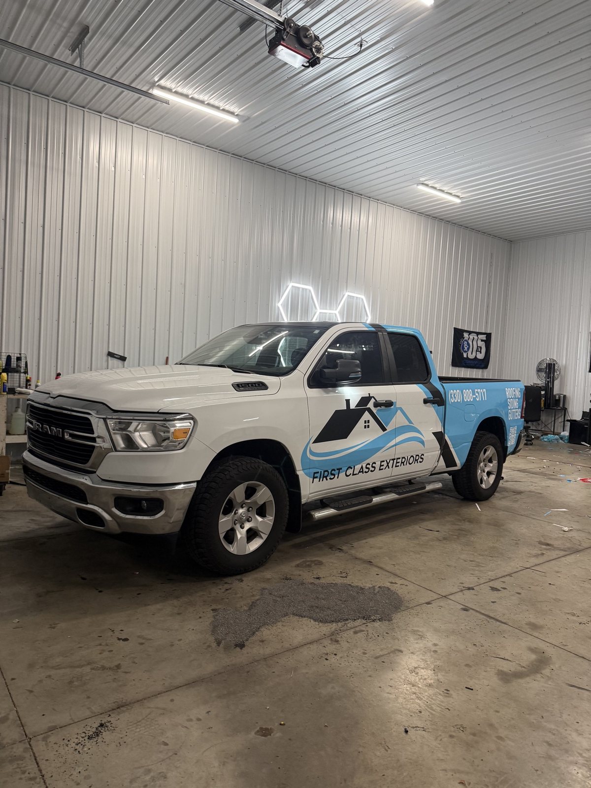 Finished First Class Exteriors Ram 1500 commercial wrap, full side view inside the shop