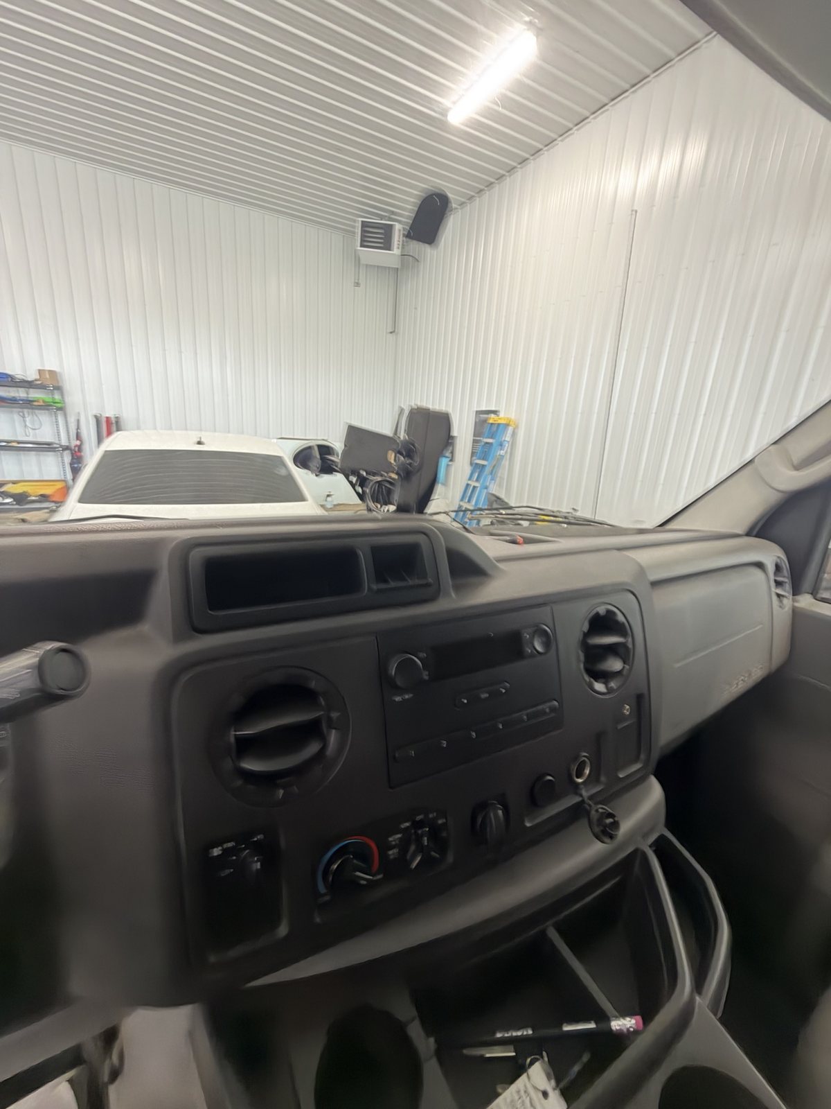 Ford E-350 work van dash with the stock radio, before the upgrade
